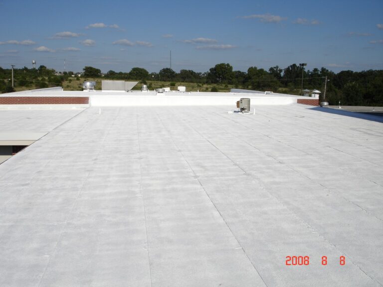 Flat white roof with elastomeric coating.